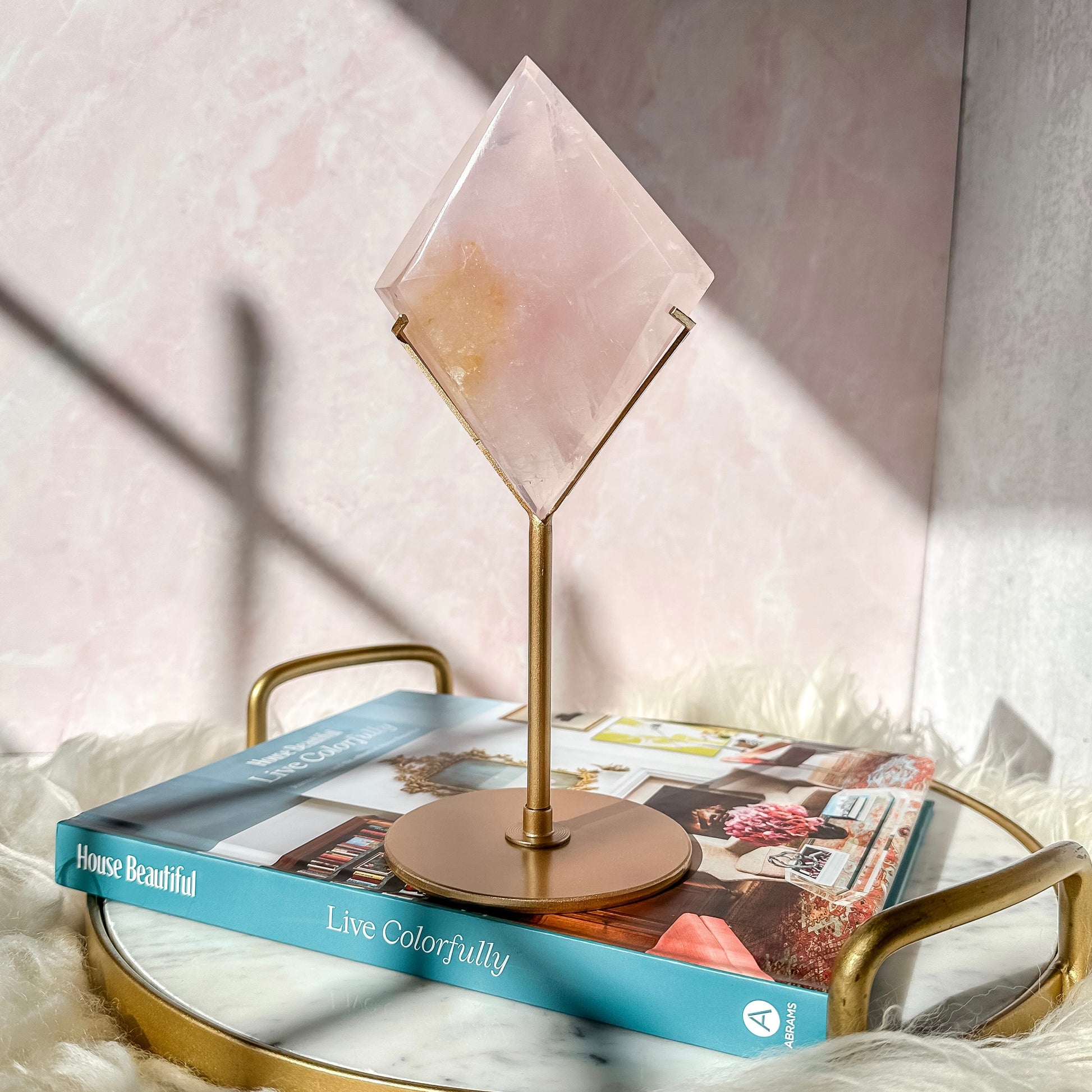 Rose Quartz Diamond on a Gold Stand